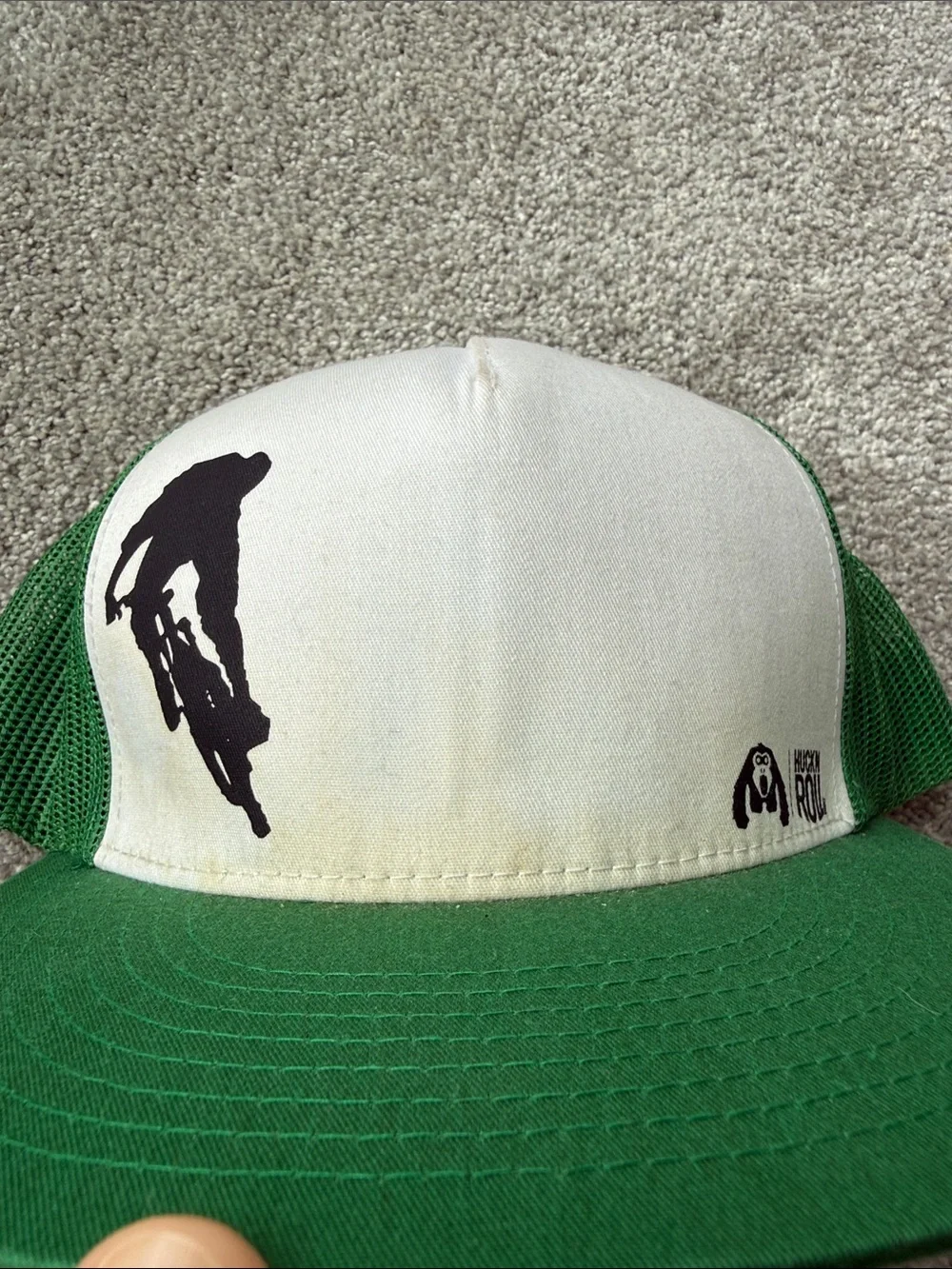 Huck and Roll- Vintage Green and White Mesh Trucker Hat with Biking Graphic
